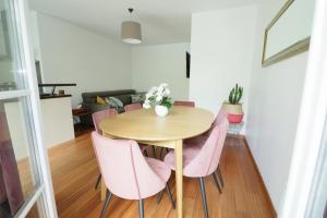 a dining room with a table and pink chairs at Appartement 7 personnes - Disneyland Paris in Serris