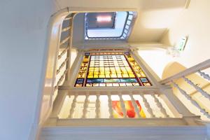 a staircase with a stained glass window on it at Quentin England Hotel in Amsterdam