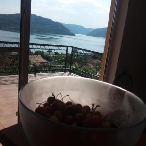 a bowl of grapes in front of a window at Casa lui Marc in Orşova