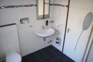 a bathroom with a sink and a toilet at Hotel Deutsches Haus in Cuxhaven