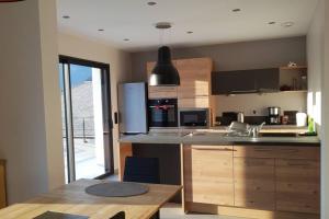 a kitchen with a sink and a counter top at Gîte L Orée Du Lac in Les Mollettes