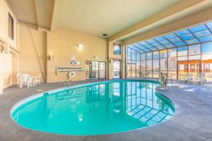 a large swimming pool in a building with a large window at Econo Lodge & Suites Clarksville in Clarksville