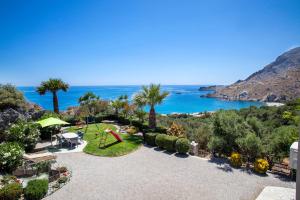 an aerial view of a garden with the ocean in the background at Nostalgia Apartments in Sellía