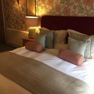 a large bed with two pillows on top of it at Plato's in Kirkby Lonsdale