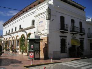 a building with a pay phone in front of it at Plaza Chica in Cartaya