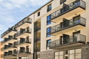 an apartment building with balconies on the side of it at Hôtel La Villa Port d'Antibes & Spa in Antibes