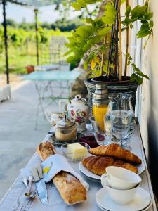 a table topped with plates of food and pastries at Chateau le Truch in Montussan