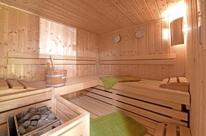 a wooden sauna with two beds in it at Ferienwohnungen Schantl in Schoppernau