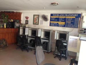 a waiting room with desks and chairs in a restaurant at Grand View Guesthouse in Phnom Penh