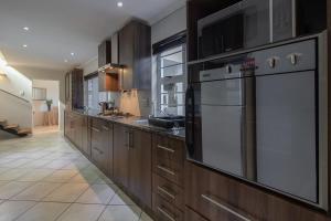 a kitchen with wooden cabinets and a large appliance at Dockside in Port Alfred
