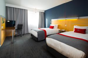 Holiday Inn Express Cambridge, an IHG Hotel tesisinde bir odada yatak veya yataklar