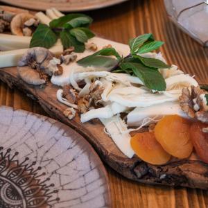 a plate of food on a wooden table at Harbour Fethiye in Fethiye