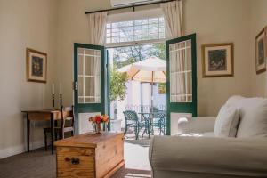 a living room with a bed and a table at 54 on Middle - Solar-powered stay in Graaff-Reinet