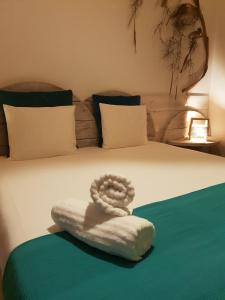 a bed with a white towel on the bed at Cactus Host in Las Palmas de Gran Canaria