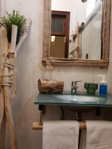 a bathroom with a sink and a mirror at Cactus Host in Las Palmas de Gran Canaria