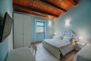 a bedroom with a bed and a tv in it at Alle Pendici del Conero in Sirolo