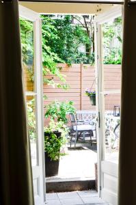 an open door to a patio with a bench at Family Hotel Kooyk in Amsterdam