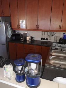 a kitchen with a blender on a counter at Mackenzies Accommodation in East London
