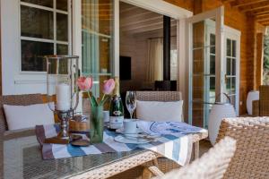 a table with flowers and candles on a patio at Chalet Bischofsmühle in Helmbrechts