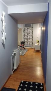 a hallway with blue walls and wooden floors and a room at Liberty in Belgrade +11 photos
