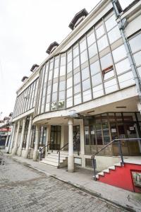a large building with a red carpet in front of it at Apartmani Genčić 3 in Kladovo