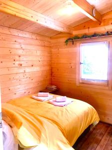 a room with a bed in a wooden cabin at Wild Atlantic Way Cabin in Ballyheigue