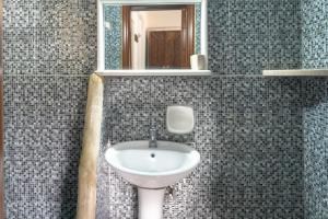 a bathroom with a sink and a mirror at Alexandros by the Beach - Serifos in Livadakia