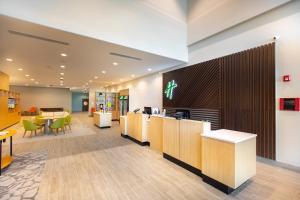 an office lobby with a reception desk and chairs at Holiday Inn - Kansas City - Northeast, an IHG Hotel in Kansas City
