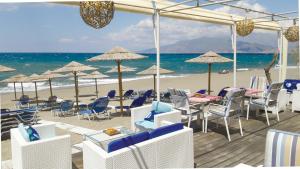 - une plage avec des chaises, des tables et des parasols dans l'établissement Ammos Kalamaki - for holidays at the beach, à Kalamaki