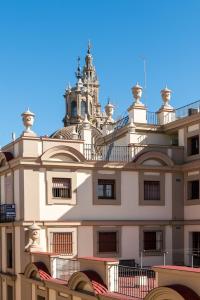 a building with a tower on top of it at Constitución Terraza in Seville