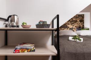 a room with a bed and a shelf with books at Fani&Rozi B&B in Maribor