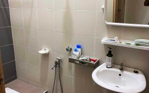 a bathroom with a sink and a mirror at Umbai Homestay - Wak Sidin House in Melaka +21 photos