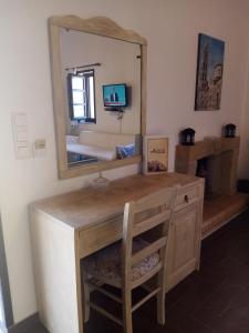 a bathroom with a wooden vanity with a mirror at Traditional Apartments Plagiaki in Neon Oitilon