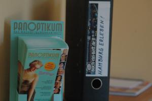 a package of a dvd and a box on a table at Buch-Ein-Bett Hostel in Hamburg