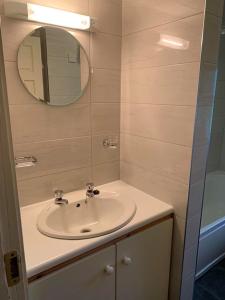 a bathroom with a sink and a mirror at Amber Cottage in Killarney