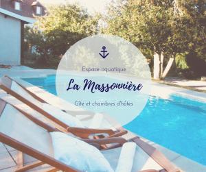 a group of chaise lounge chairs next to a swimming pool at La Massonnière Gîte et chambres d'hôtes in Mondion