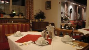 a table in a restaurant with a white table cloth at Pension Dorfplatzl in Fusch an der Glocknerstraße