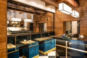 a restaurant with blue stools and a bar at Corte Guelfa in Florence