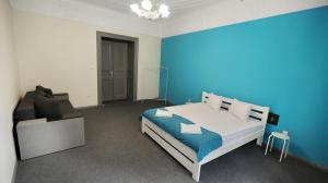a bedroom with a bed and a blue wall at Family Hostel Lviv in Lviv