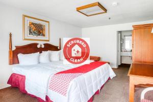 a hotel room with a bed with a sign on it at OYO Hotel San Antonio East in San Antonio