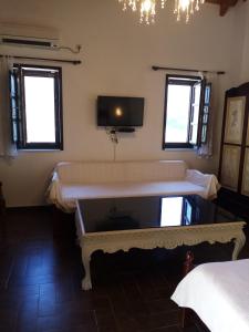 a room with a large bed and a tv on the wall at Traditional Apartments Plagiaki in Neon Oitilon