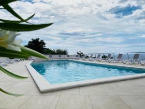 a swimming pool on the roof of a resort at Appartamenti Pousada Michelino in Parghelia