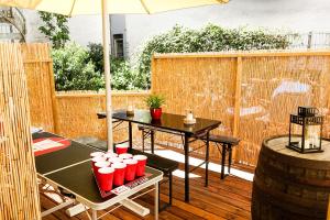 a patio with two tables and an umbrella at City Apartment Reeperbahn Hamburg in Hamburg