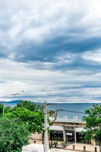 a building with a street light in front of the ocean at B12 new & modern seafront apartment in Alexandroupoli