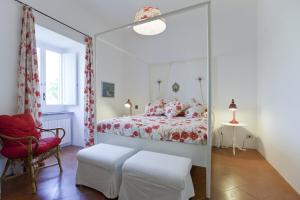 a bedroom with a bed and a red chair at Villa Stella in Massa Lubrense +21 photos