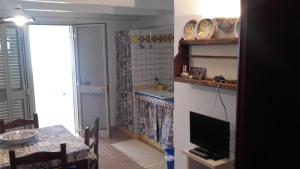 マルサラにあるCasa Vacanze Escondidoのキッチン(テーブル付)、テレビが備わります。