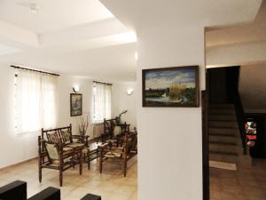 a living room with chairs and a painting on the wall at Hotel Teddy House in Bansko