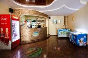 a store with a cocacola soda machine and a counter at Оазис in Zalishchyky
