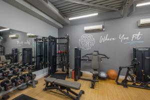 a gym with lots of equipment and a wall with graffiti at Holiday Inn Swindon, an IHG Hotel in Swindon