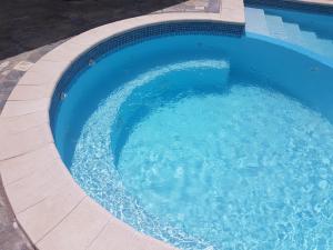 a large swimming pool with a circular poolvisor at Hotel Mirage in Varcaturo